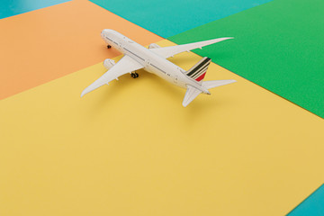 Model airplane a on difference colorful bright background,travel concept