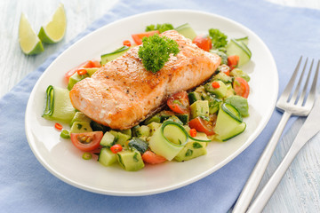Grilled salmon fillet with vegetable salad.