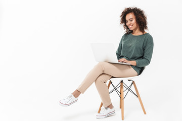 Attractive young african woman sitting on a chair - Powered by Adobe