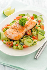 Grilled salmon fillet with vegetable salad.