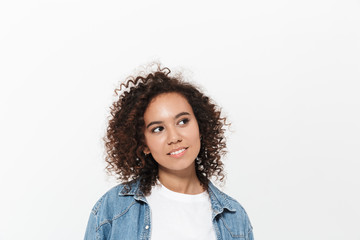 Beautiful young happy african woman posing isolated over white wall background.