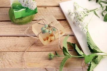 Natural soap,  plants and berries on a wooden table, spa procedures, body care, healthy lifestyle