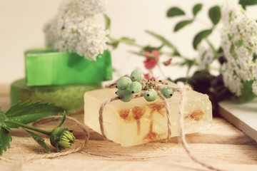 Natural soap,  plants and berries on a wooden table, spa procedures, body care, healthy lifestyle