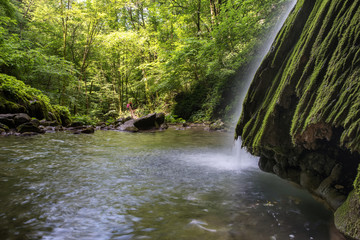Beautiful waterfall falling from a rock covered by moss. Kot waterfall, San Leonardo village close...