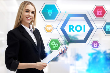 The concept of business, technology, the Internet and the network. A young entrepreneur working on a virtual screen of the future and sees the inscription: ROI