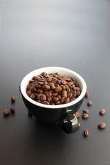 coffee bean in cup on black background