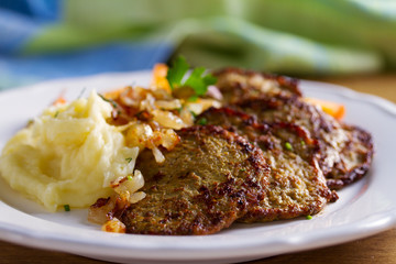 Beef liver pancakes with mashed potato and vegetables. Liver side dish