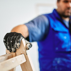 Worker painting walls inside the house - renovation fixes.