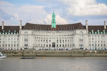 Fototapeta na wymiar London County Hall seen from the north bank of the River Thames