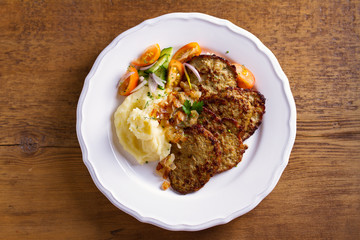 Beef liver pancakes with mashed potato and vegetables. Liver side dish. View from above, top studio shot