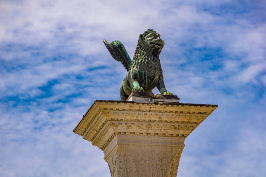 Sculpture depicting image of lion with wings, symbol of Venice, on the top of the column at San Marco, Italy