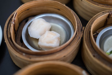 Closeup of Dim Sum in bamboo steamer, Chinese cuisine.