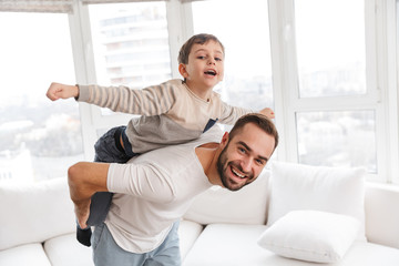 Happy father and his son piggyback riding