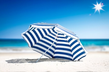 Summer time on beach and free space for your decoration. Blue and white umbrella with landscape of...