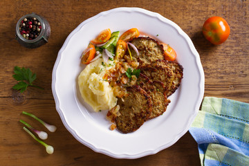 Beef liver pancakes with mashed potato and vegetables. Liver side dish. View from above, top studio shot