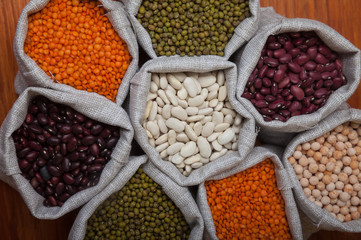 Fototapeta premium beans, lentils, peas, soybeans in bags close-up. Natural food