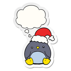 cute cartoon penguin wearing christmas hat and thought bubble as a printed sticker