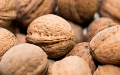 A bunch of dried walnuts close up macro shot, image for background.