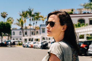 Young woman wearing sunglasses on holidays in Canary Island, Gran Canaria, Spain.