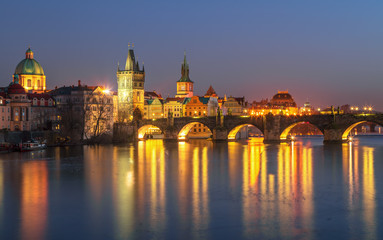 Sunset view on Prague old town and iconic Charles bridge on Vltava river, Czech Republic