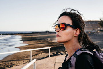 Young woman wearing sunglasses on holidays in Canary Island, Gran Canaria, Spain.