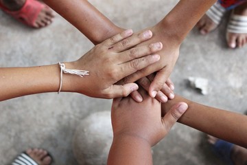 Children hold hands to show unity