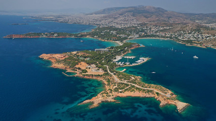 Fototapeta premium Aerial drone photo of famous luxurious Lemos peninsula in Vouliagemeni area with iconic celebrity sandy beach of Asteras, Athens riviera, Glyfada, Attica, Greece