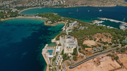 Aerial drone photo of famous luxurious Lemos peninsula in Vouliagemeni area with iconic celebrity sandy beach of Asteras, Athens riviera, Glyfada, Attica, Greece