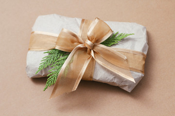 Gift wrapped in brown paper and tie satin ribbon. Christmas presents. Delivery package. Soft pouch. 