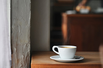 Coffee morning with black coffee on wooden desk.