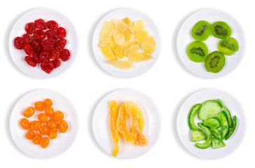 Set plates candied dried tropical fruits on the white background isolation, top view