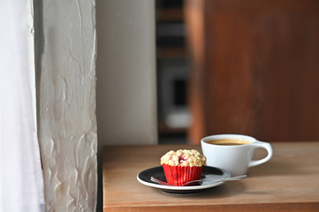 Breakfast with black coffee and muffin homemade on wood table.