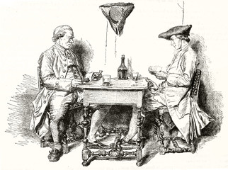 Two medieval elegant people playing card on a little table and drinking wine. Old gray tone  illustration depicting two card players. After Messoinier publ. on Magasin Pittoresque Paris 1848