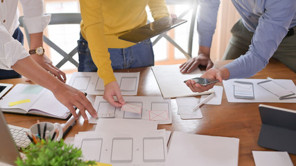 Snap shot web designer working on office desk, Website wireframe sketch by development.