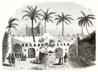Ancient oriental courtyard with arabian people inside and high palms. Typical architecture in Gadames Libya. By unidentified author publ. on Magasin Pittoresque Paris-1848