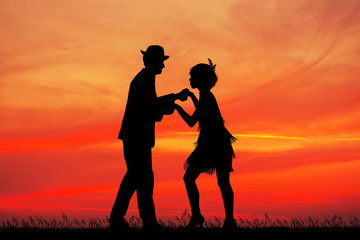 Obraz premium couple dances charleston at sunset
