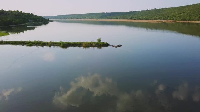 Flying over the river on a sunny summer day. Dniester river of Moldova republic.