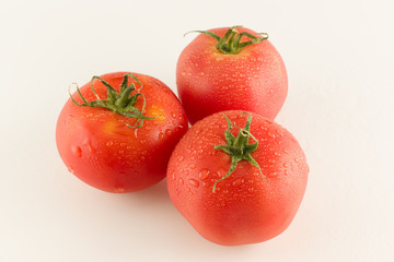 ripe red varietal tomatoes isolated