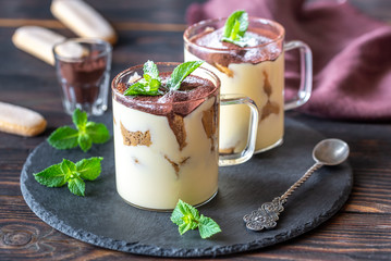 Two glass mugs of tiramisu