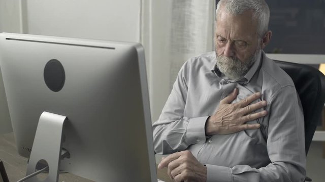 Senior man having an heart attack at home
