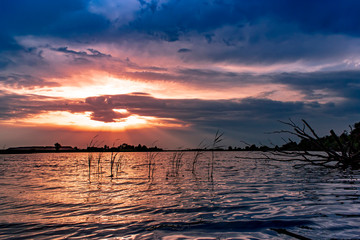 Fototapeta na wymiar Beautiful purple summer sunset on the lake.