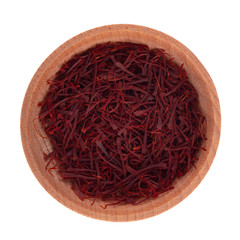 heap of saffron in wooden cup isolated on white background. top view