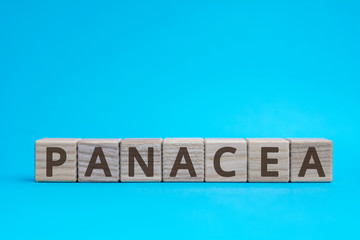 panacea inscription wooden cubes with letters on a blue background