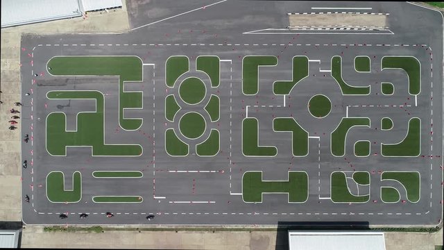Aerial Top view : a group of motorcycles riding gymkhana in driving field road.