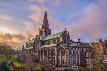 Beautiful Glasgow St Mungo’s Cathedral illuminated clouds in sunset	 - obrazy, fototapety, plakaty