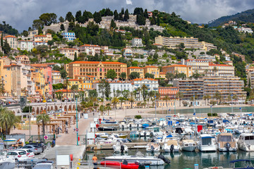 Menton. Antique multi-colored facades of medieval houses on the shore of the bay.