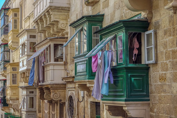 View of typical buildings with colorful balconies in Valletta, Malta