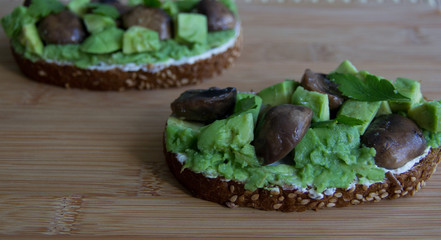 Sandwich with avocado, cottage cheese and mushrooms