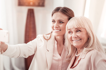 Mother and daughter making photos on a smartphone