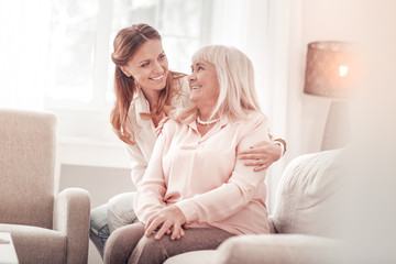 Amazing mother and daughter smiling tenderly to each other